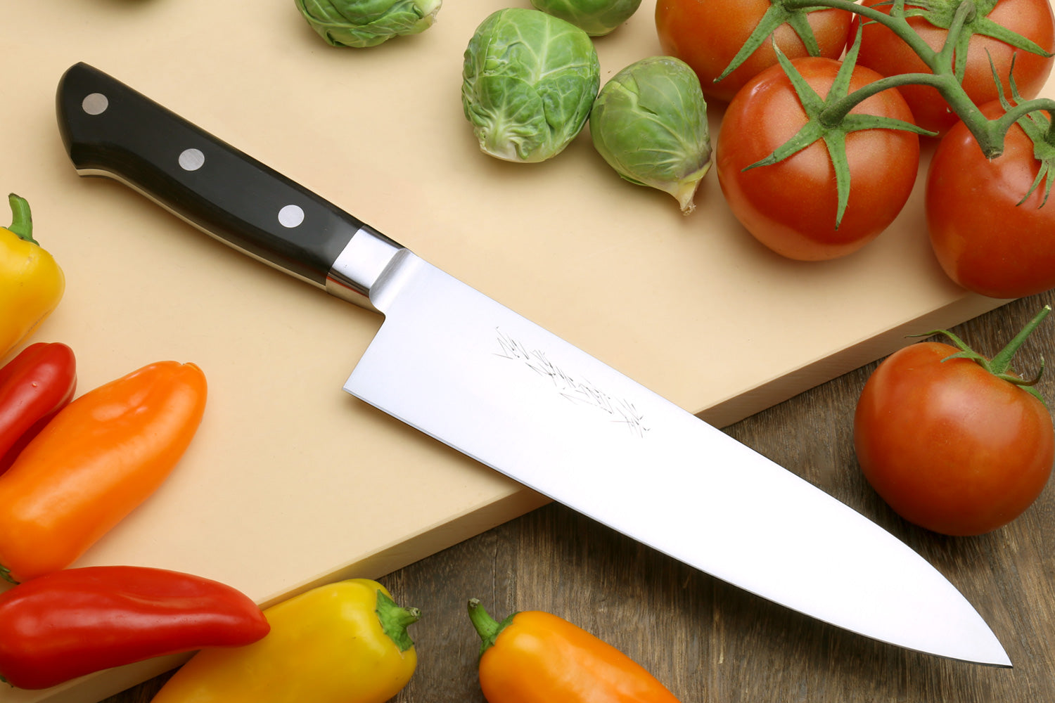 Double-edged deba fillet knife with dark handle and silver blade, angled view