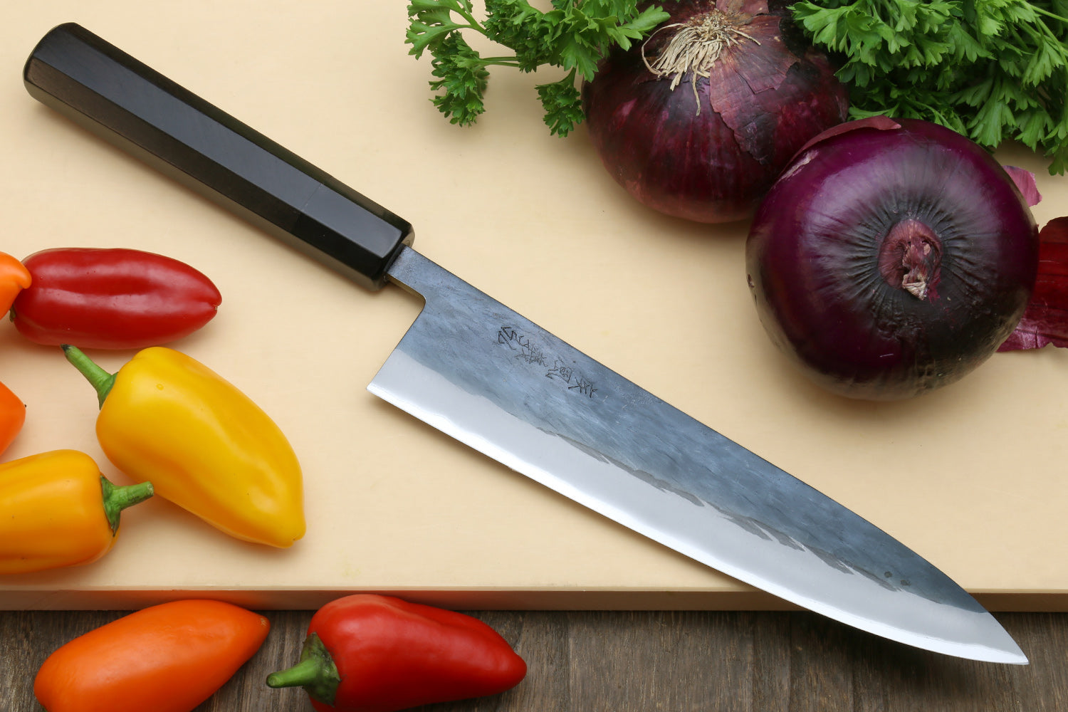 Chef's gyuto knife with black handle and blue steel clad stainless blade