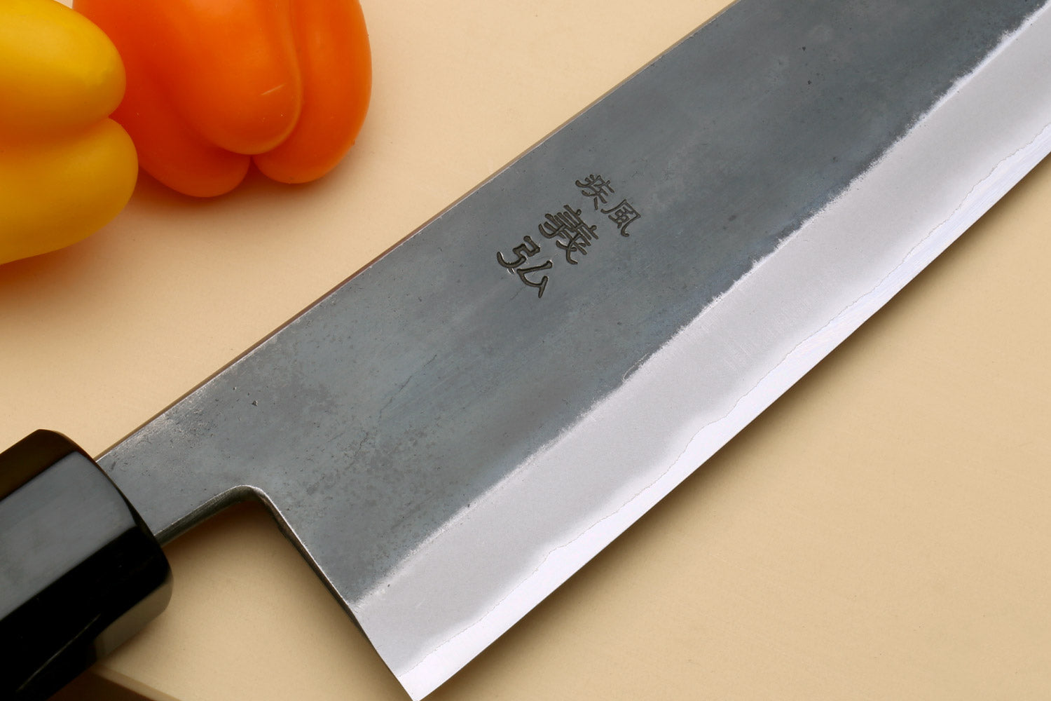 Stainless clad gyuto blade with markings and polished edge, Kaede wood handle