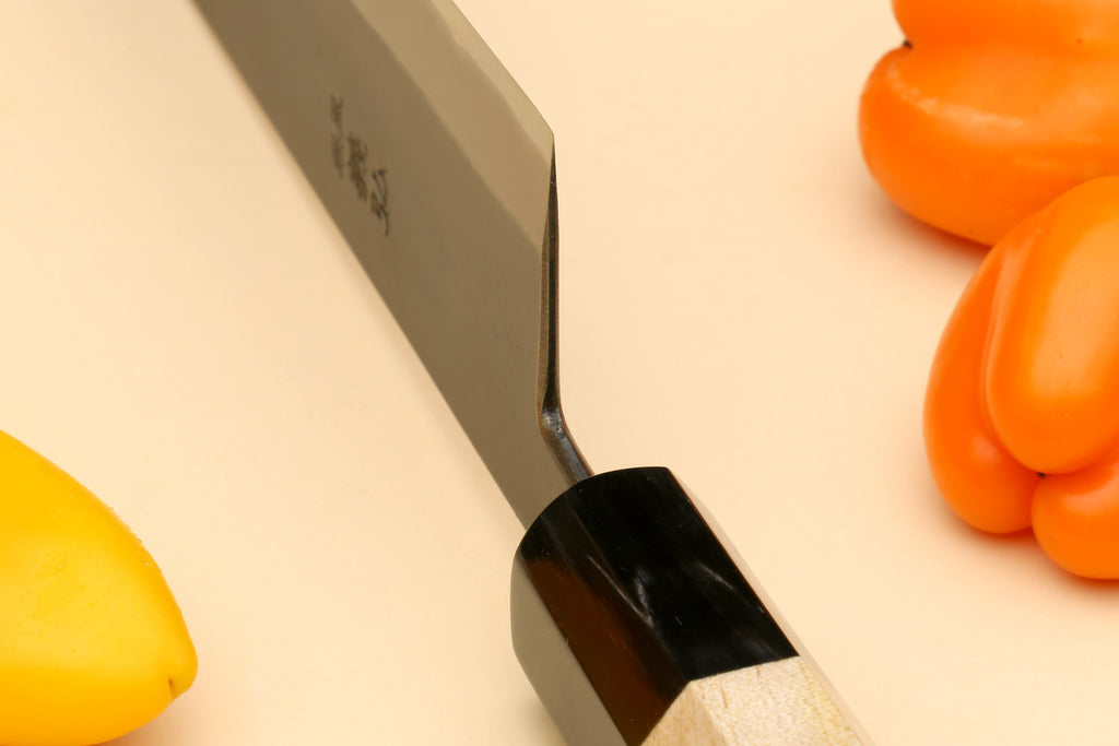 Gyuto chef knife heel with stainless blade and Kaede wood handle, black bolster