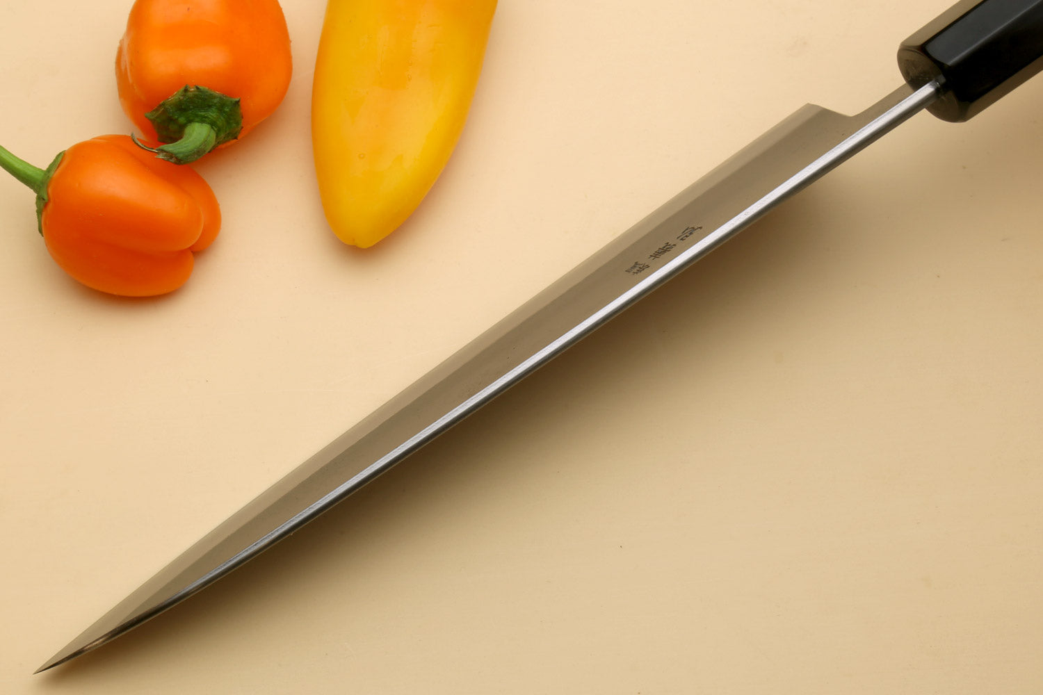 Gyuto chef knife side profile with stainless blade and Kaede wood handle