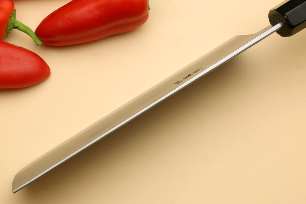 Nakiri vegetable knife side view, long gray blade with black handle