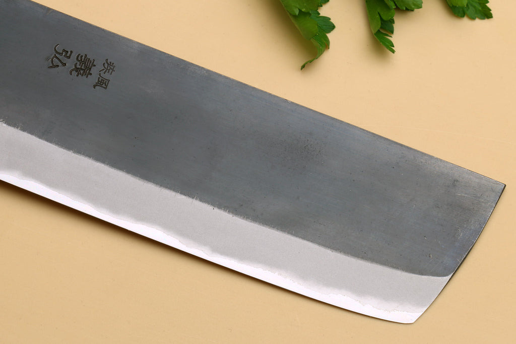Nakiri knife blade close-up showing etched characters on gray steel