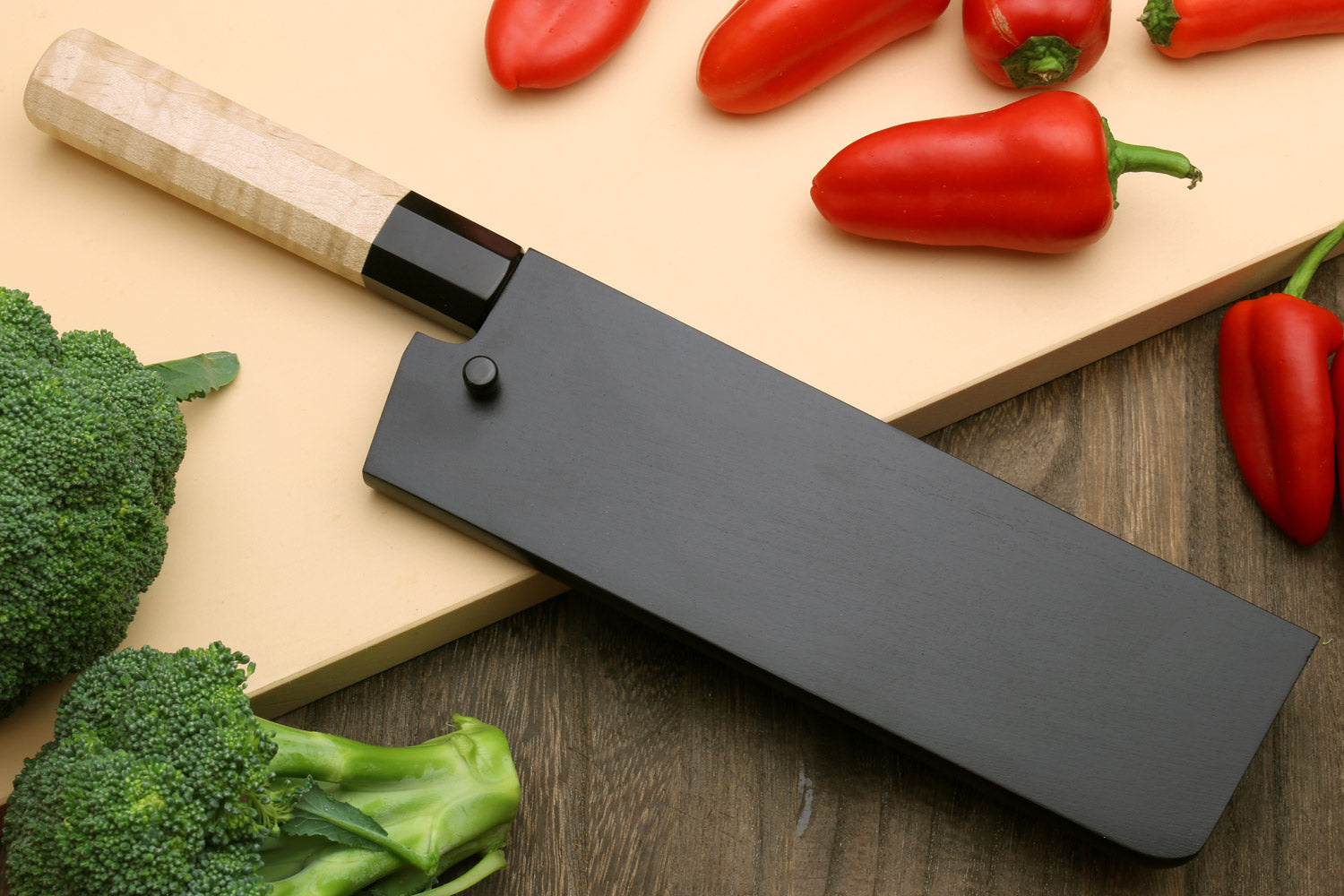 Nakiri vegetable knife front view with black handle and long gray blade
