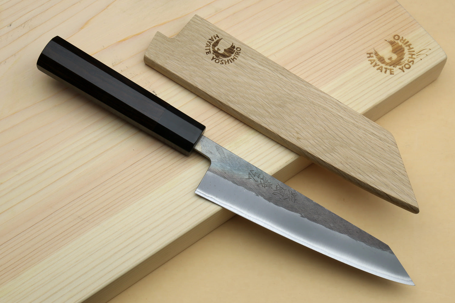 Ebony-handled boning knife with straight pointed blade and stamped markings