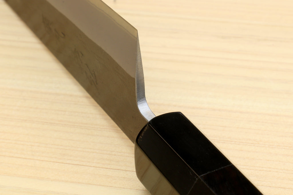 Side view of ebony-handled utility knife with straight blade and pointed tip