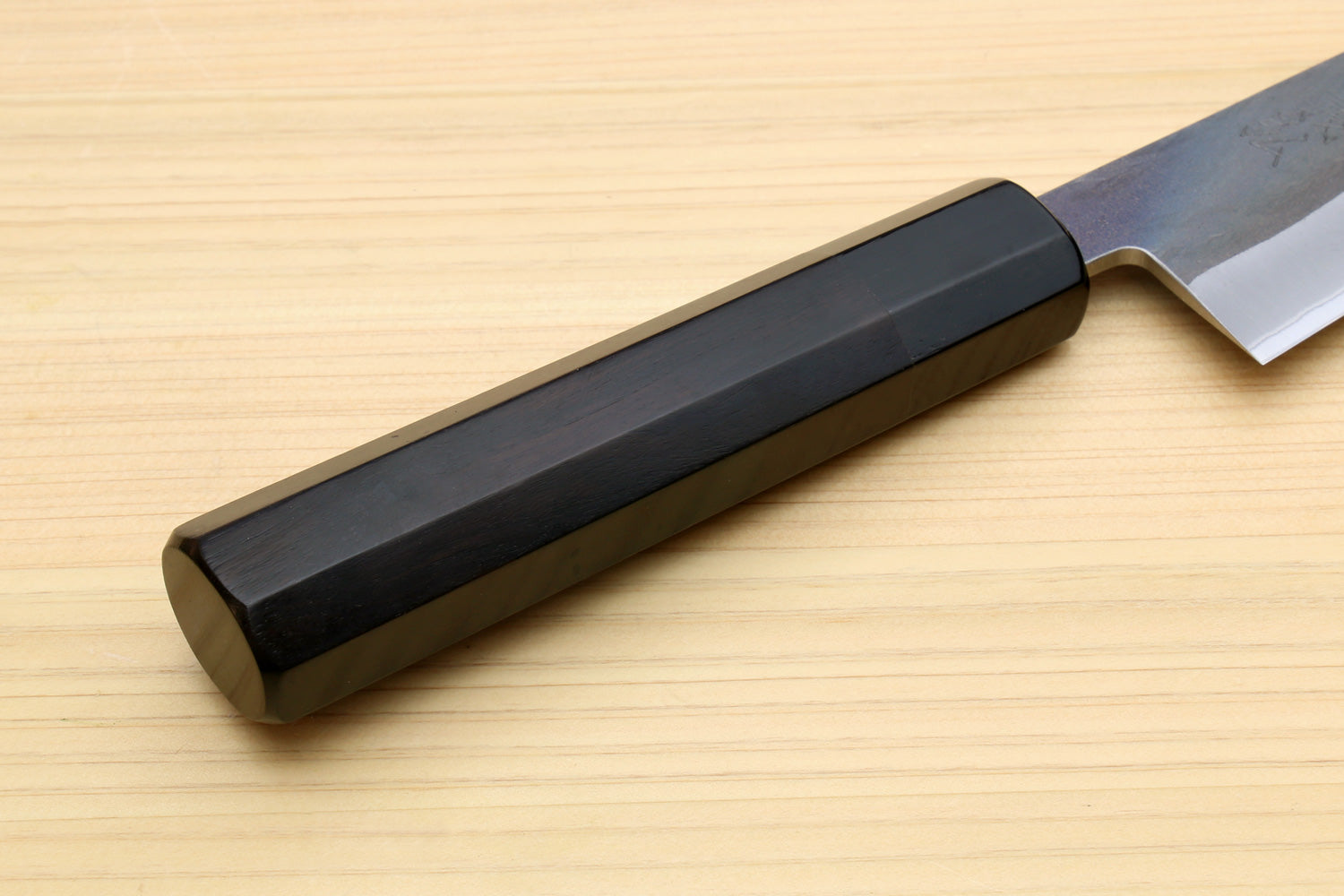 Ebony knife handle with base and blue-grey blade, utility boning style