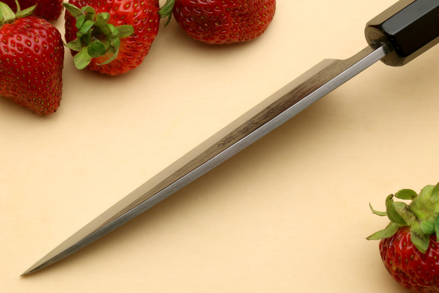 Petty utility knife with dark ebony handle and stainless blade, side angle