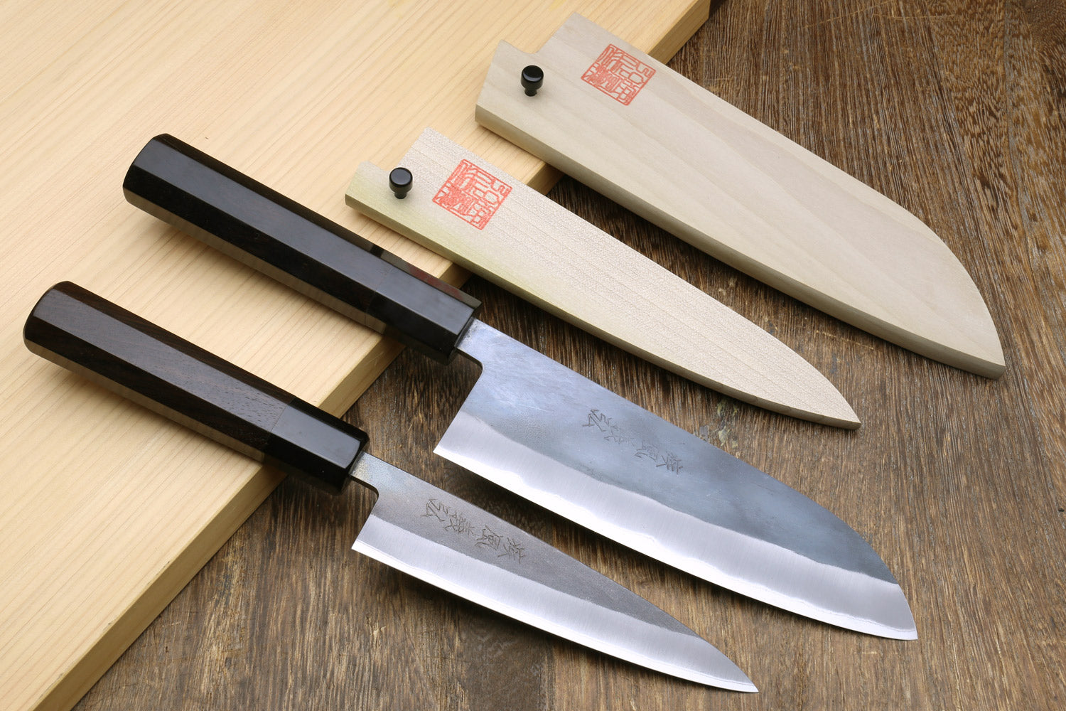 2-piece knife set with black handles, stainless blades, and stamped logo