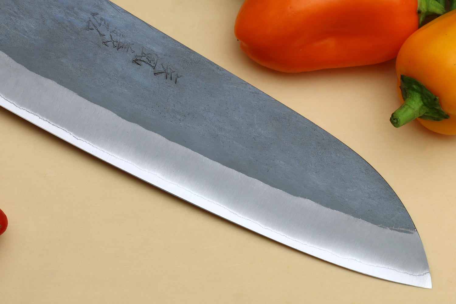 Santoku knife blade close-up with blue-gray finish and bright cutting edge