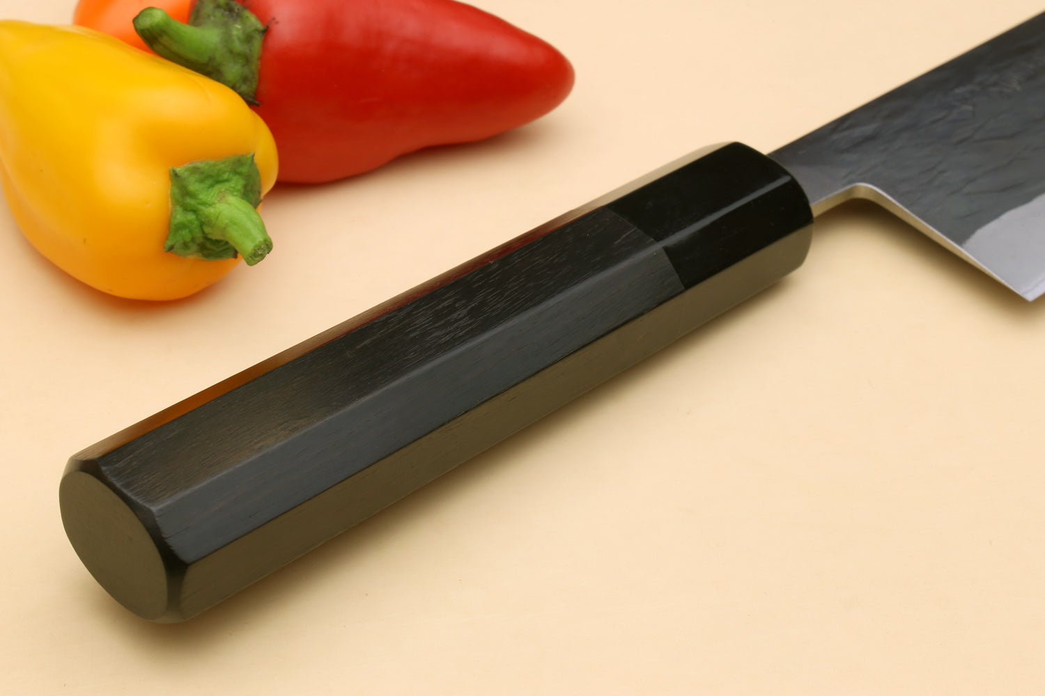 Santoku knife with dark ebony handle and silver blade, side profile