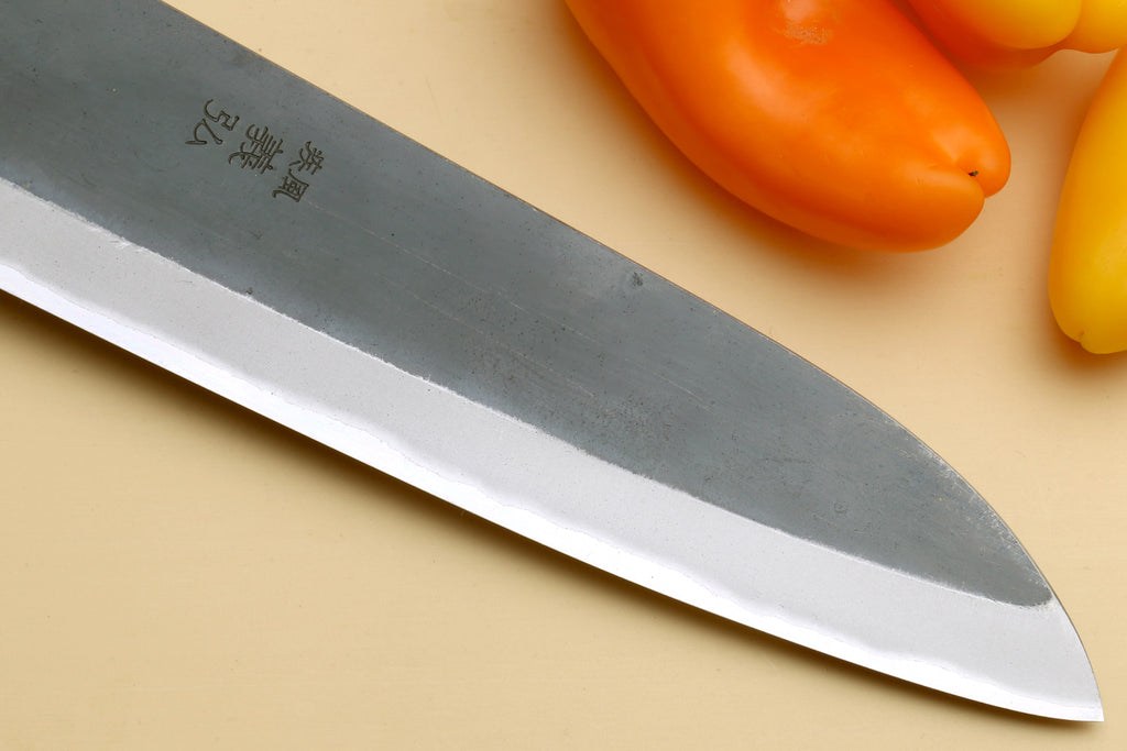 Santoku knife tip close-up with stainless blade and sharp edge