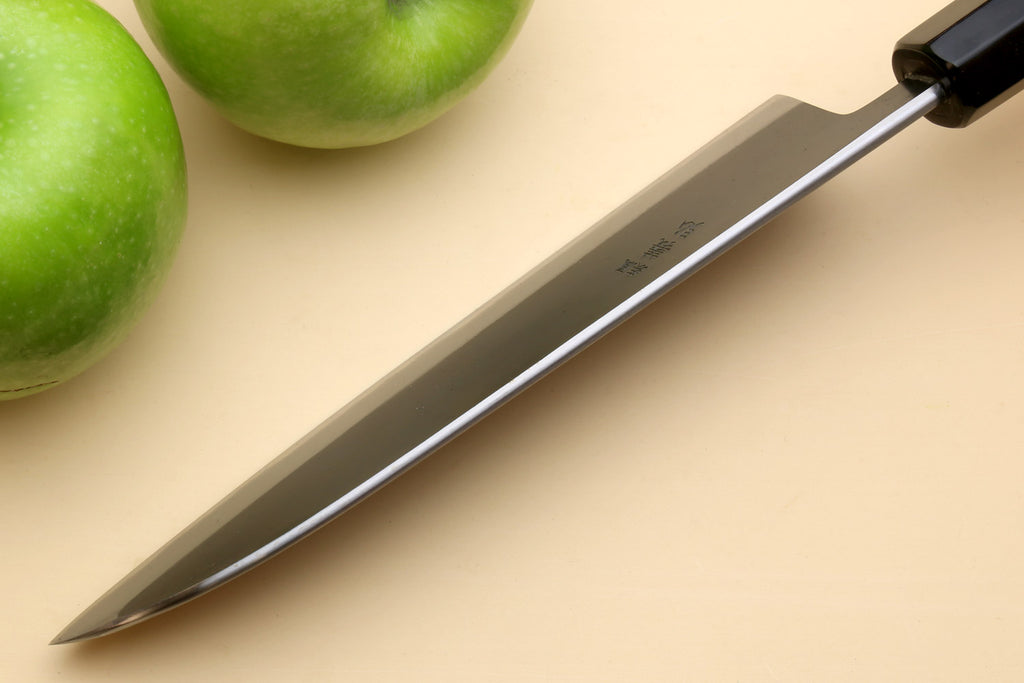 Santoku knife with stainless blade and light wood handle, side view