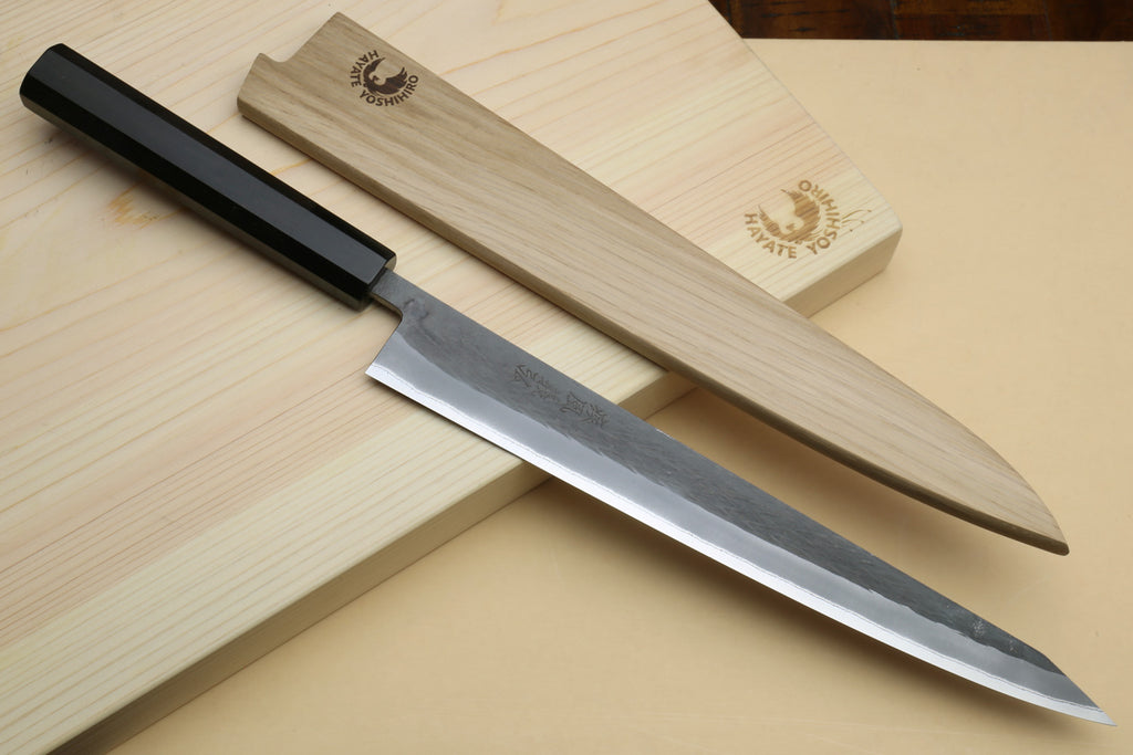 Slicer knife with ebony handle and silver blade with light wooden saya-style cover pieces.