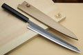 Slicer knife with ebony handle and silver blade with light wooden saya-style cover pieces.