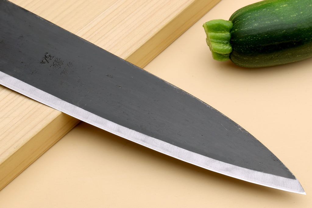 Gyuto chef knife long dark blade with polished edge and pointed tip
