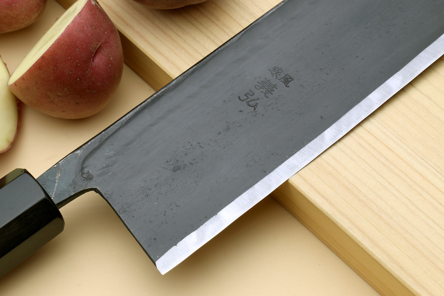 Nakiri vegetable knife blade close-up: dark steel with shiny cutting edge
