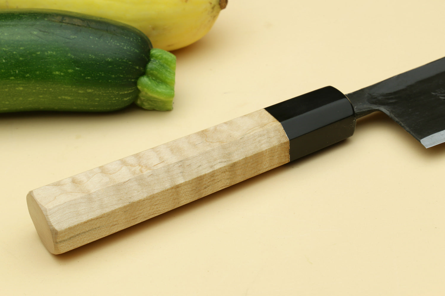 Paring knife with camphor wood handle and dark blade.