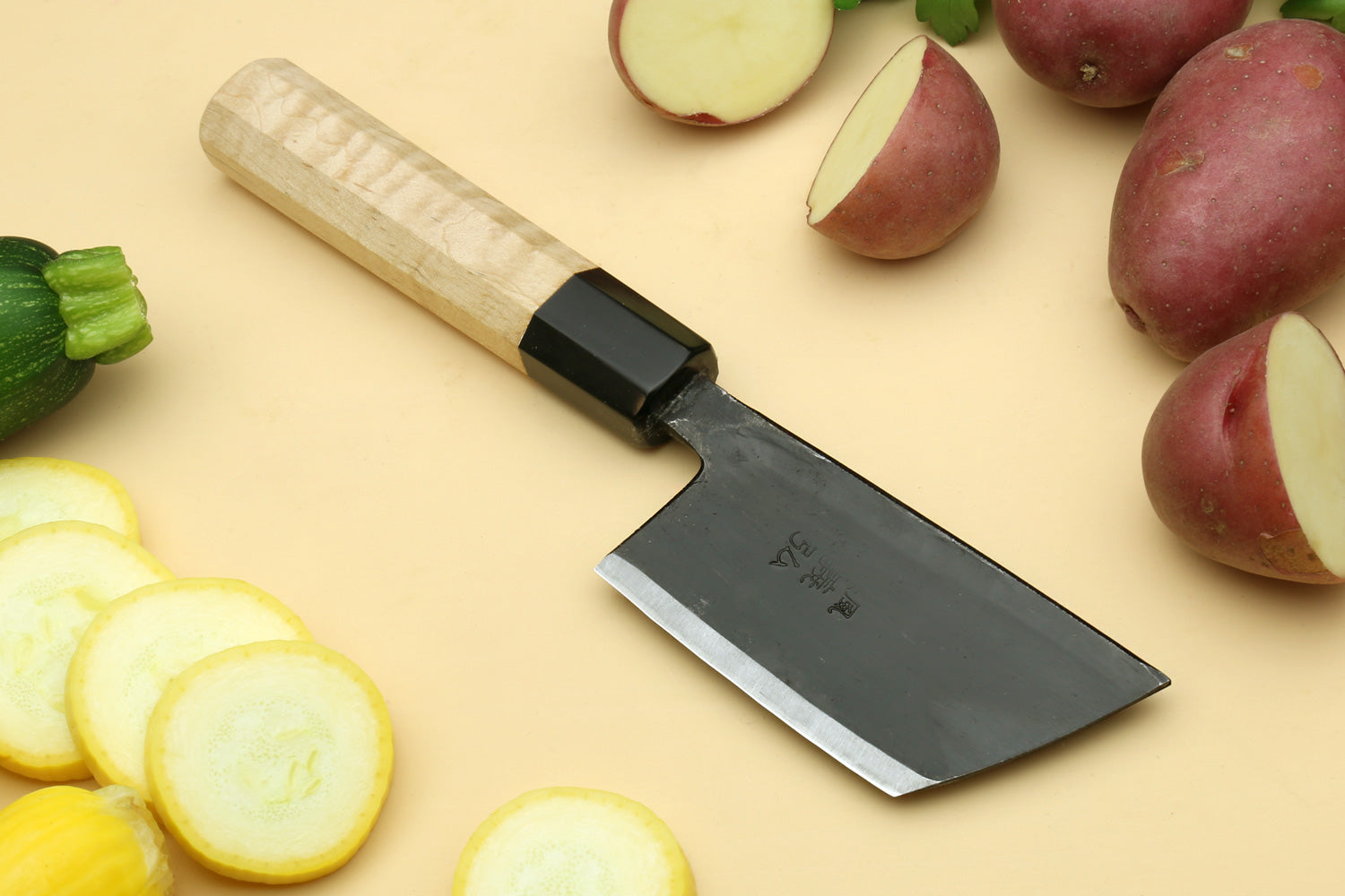 Paring knife with dark steel blade and camphor wood handle.