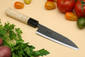 Petty utility Japanese knife with pale camphor handle and dark blade guard, pointed edge