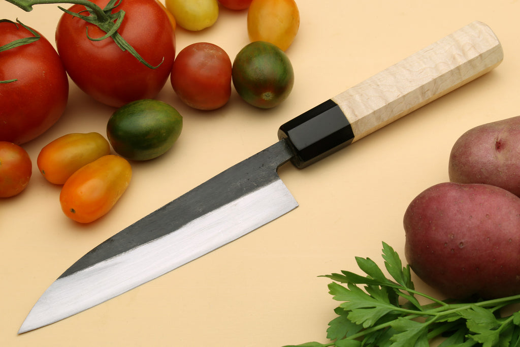 Petty utility Japanese knife with pale camphor handle, dark collar, and sharp tip