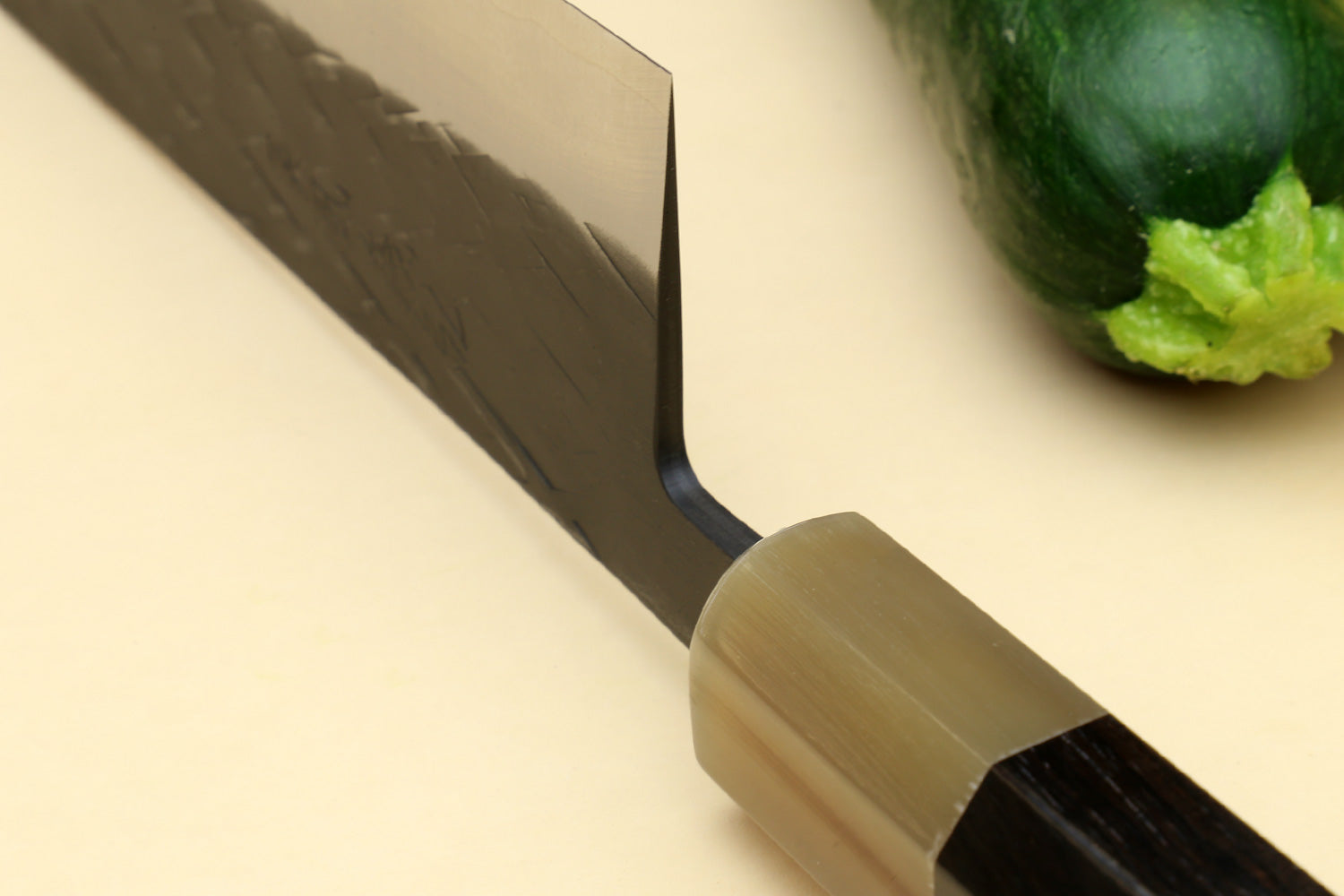 Gyuto chef's knife bolster and dark handle, black blade with speckled texture