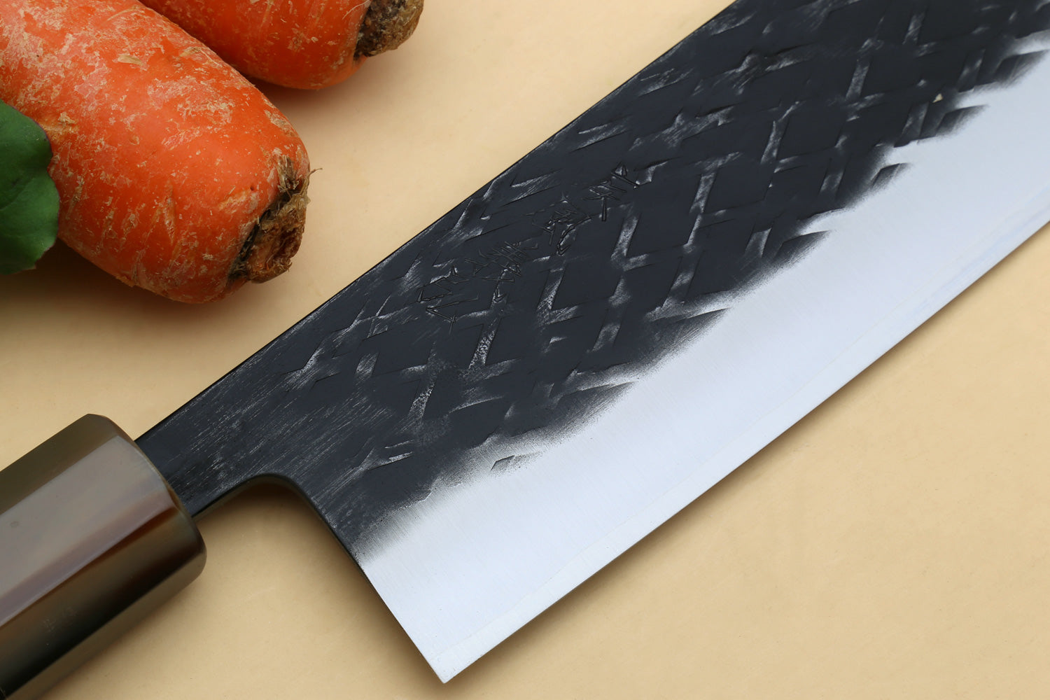 Nakiri blade close-up with dark textured face and silver cutting edge