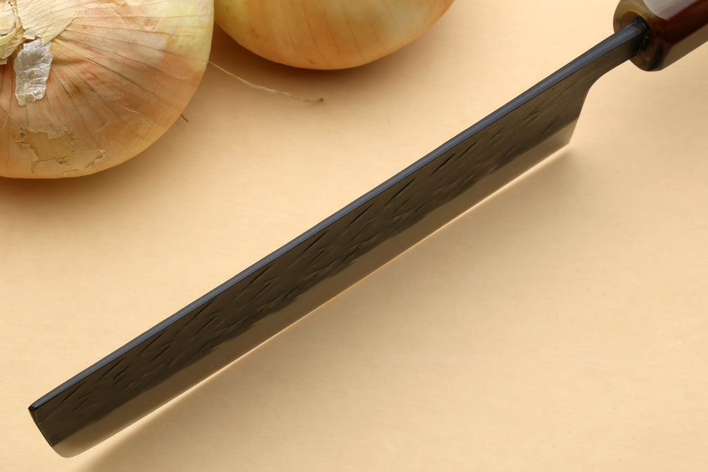 Nakiri vegetable knife with long dark hammered blade and black-tinted bolster, handle view