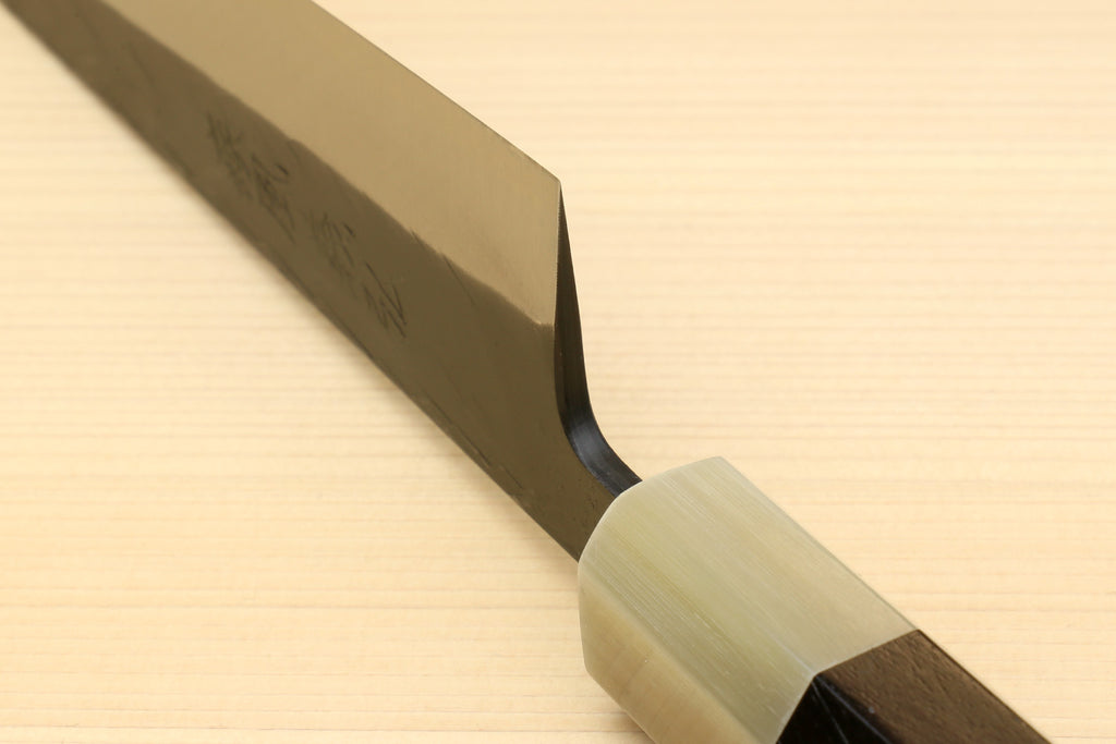 Petty-utility knife side view with dark blade and light handle with brass-colored ferrule