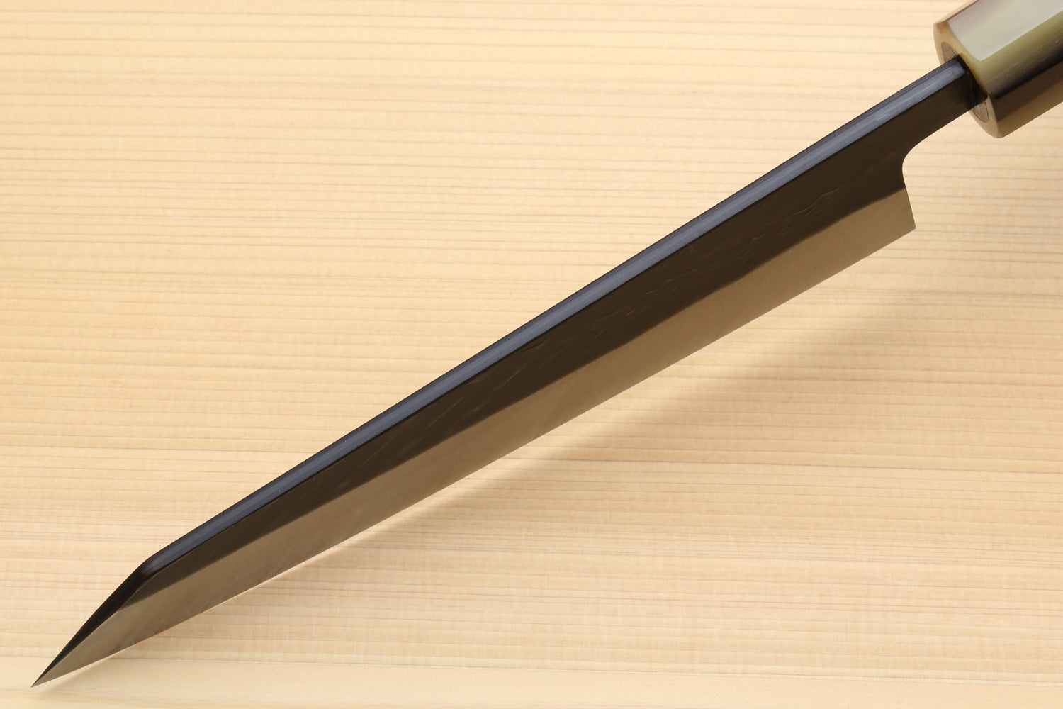 Petty-utility knife with dark blade and light handle, long pointed cutting edge