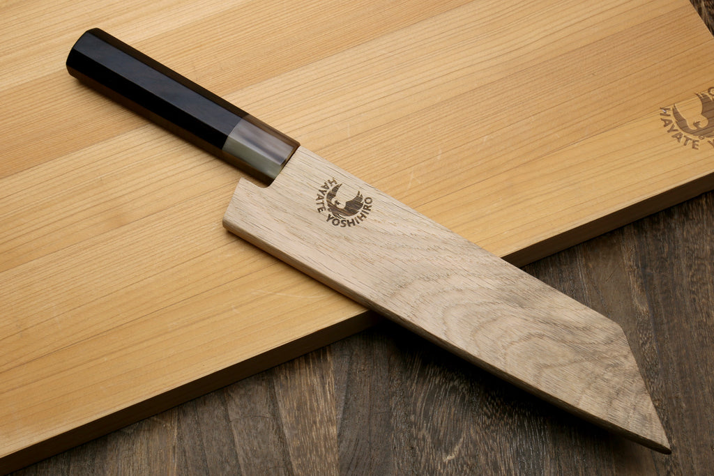 Petty-utility knife in wooden saya cover with dark handle; blade shows engraved logo