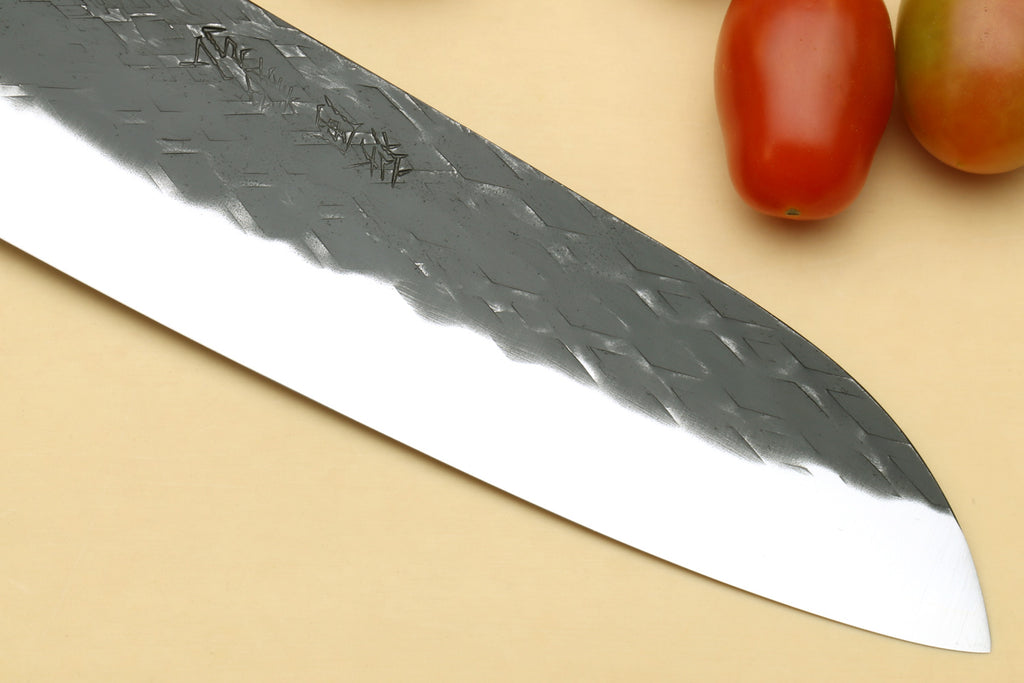 Sliced view of santoku blade with hammered texture and sharp tip