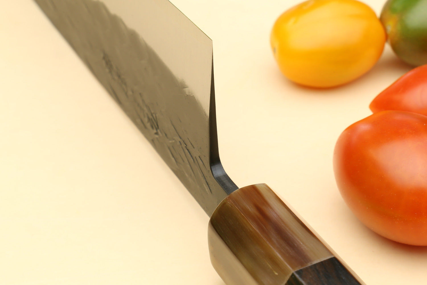 Santoku knife close-up: stainless blade with dark wood handle
