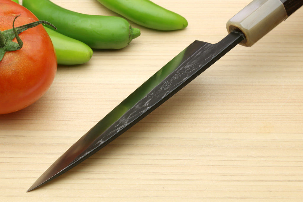 Santoku chef knife with dark handle and textured steel blade