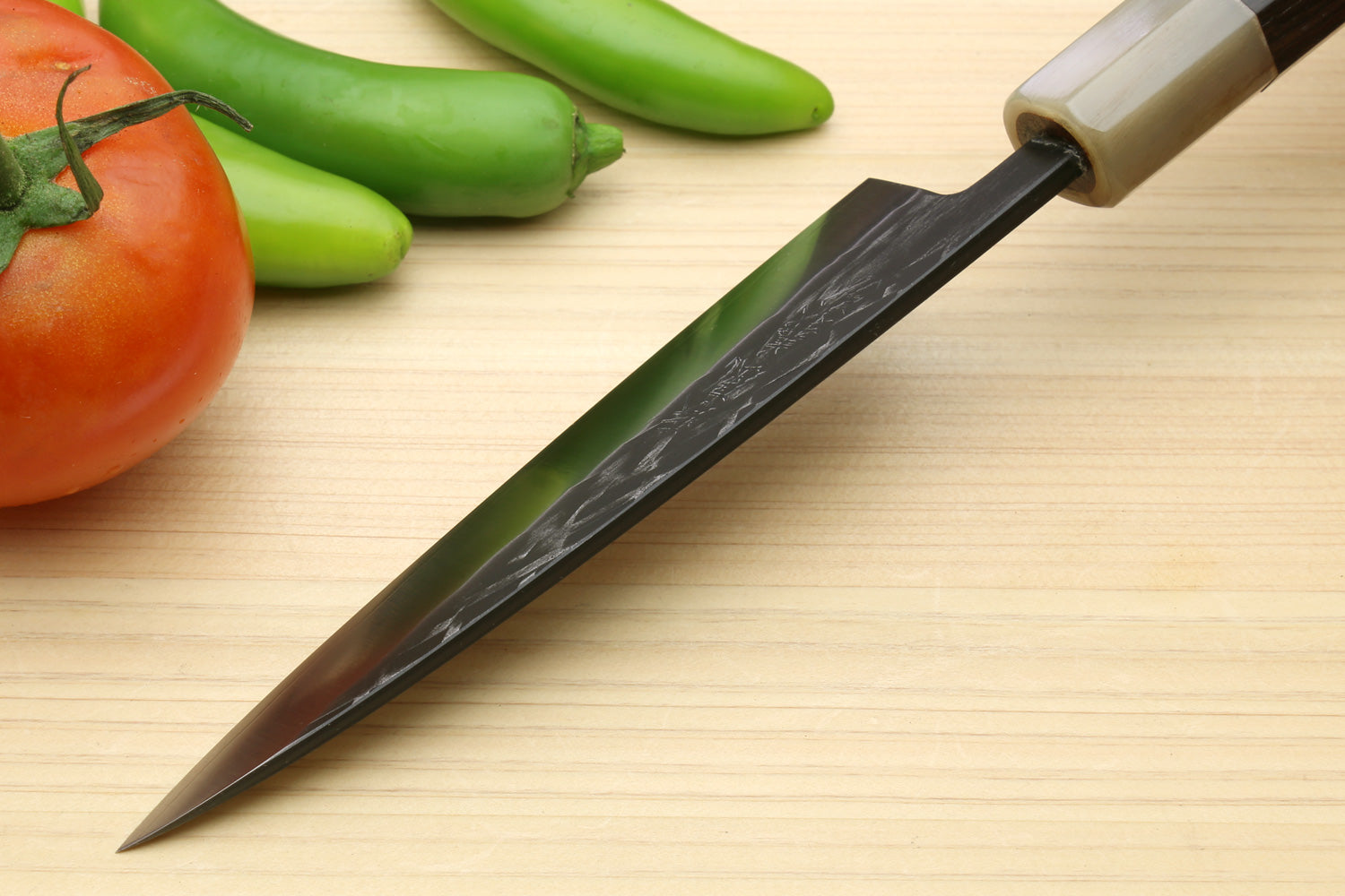 Santoku chef knife with dark handle and textured steel blade