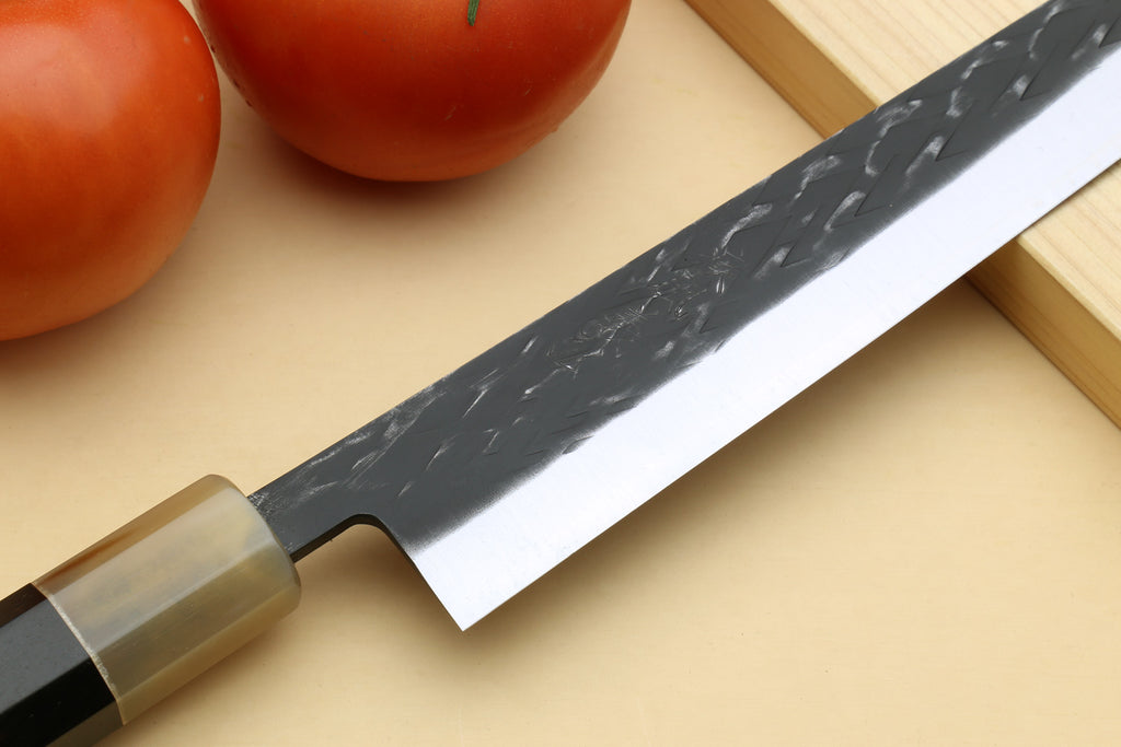 Sujihiki slicer knife with dark patterned blade, clear guard, and black spine