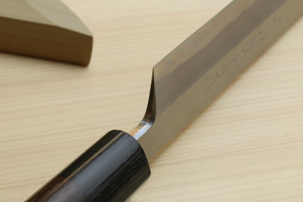 Japanese sushi knife close-up of white steel blade with dark wood handle