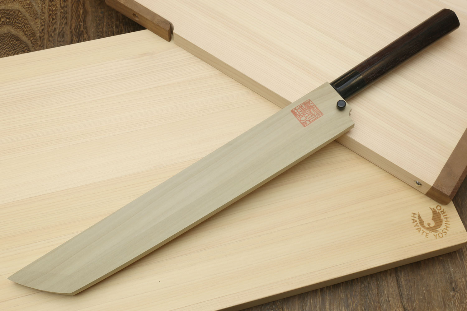 Japanese sushi sashimi knife with white steel blade and dark shitan handle, with wooden saya