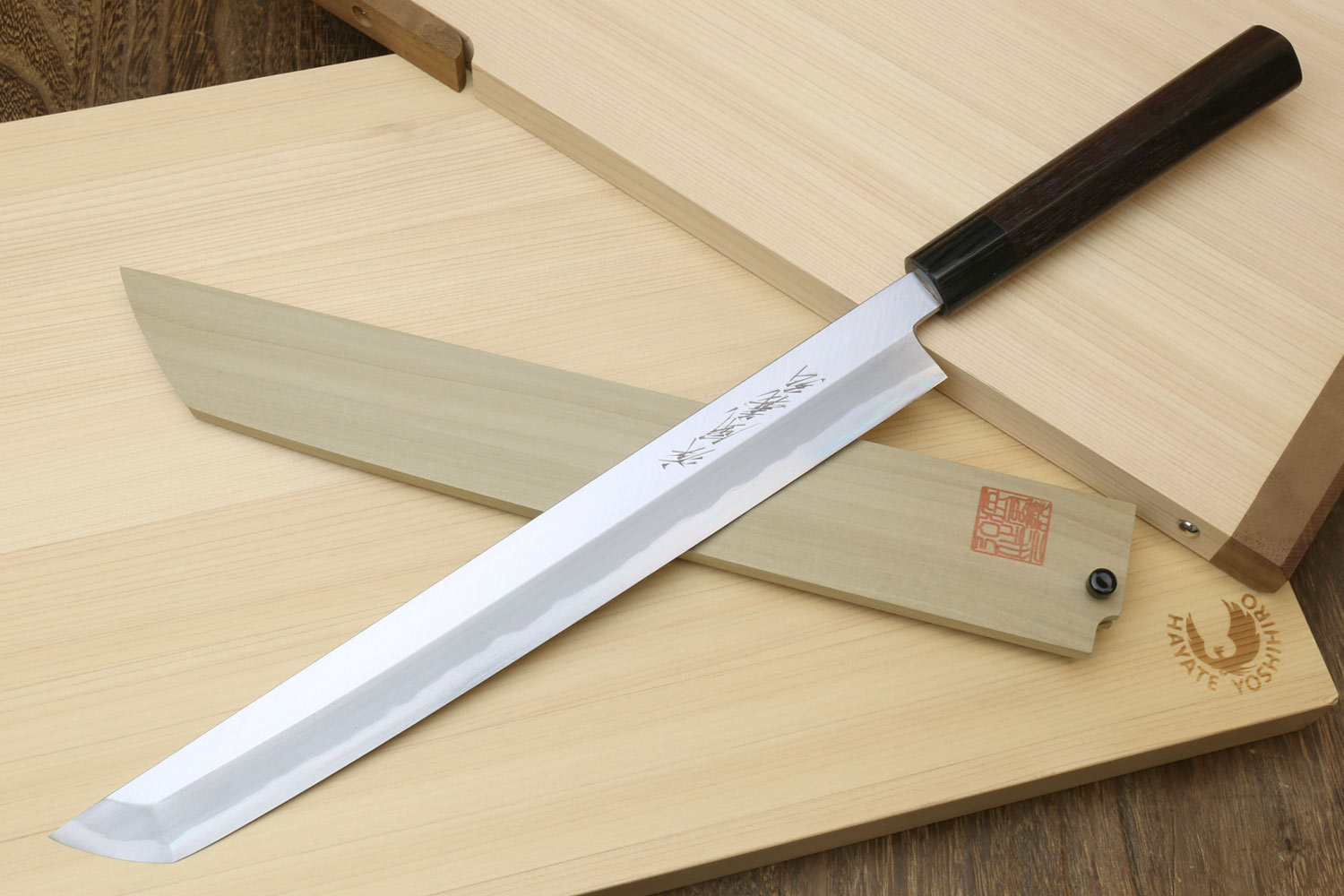 Japanese sushi sashimi knife with white steel blade and dark shitan handle, with wooden saya