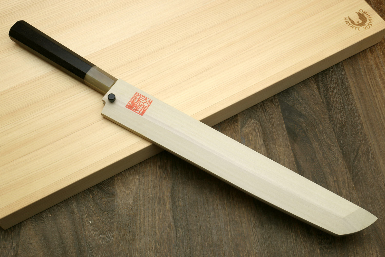 Sushi sashimi knife with pale handle and curved white blade, sakimaru point