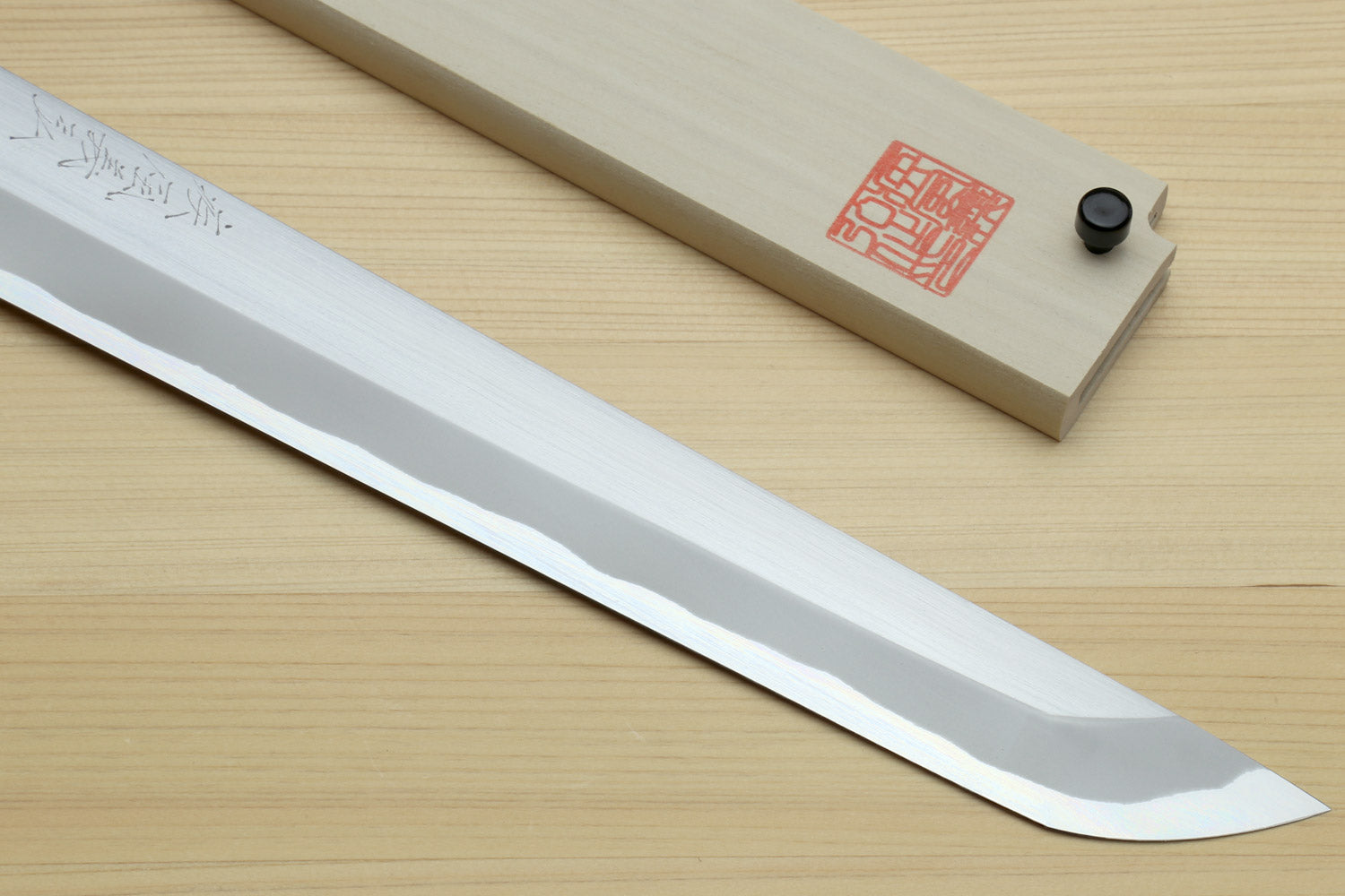 Sashimi sushi knife with white steel sakimaru tip and wooden saya, long blade close-up