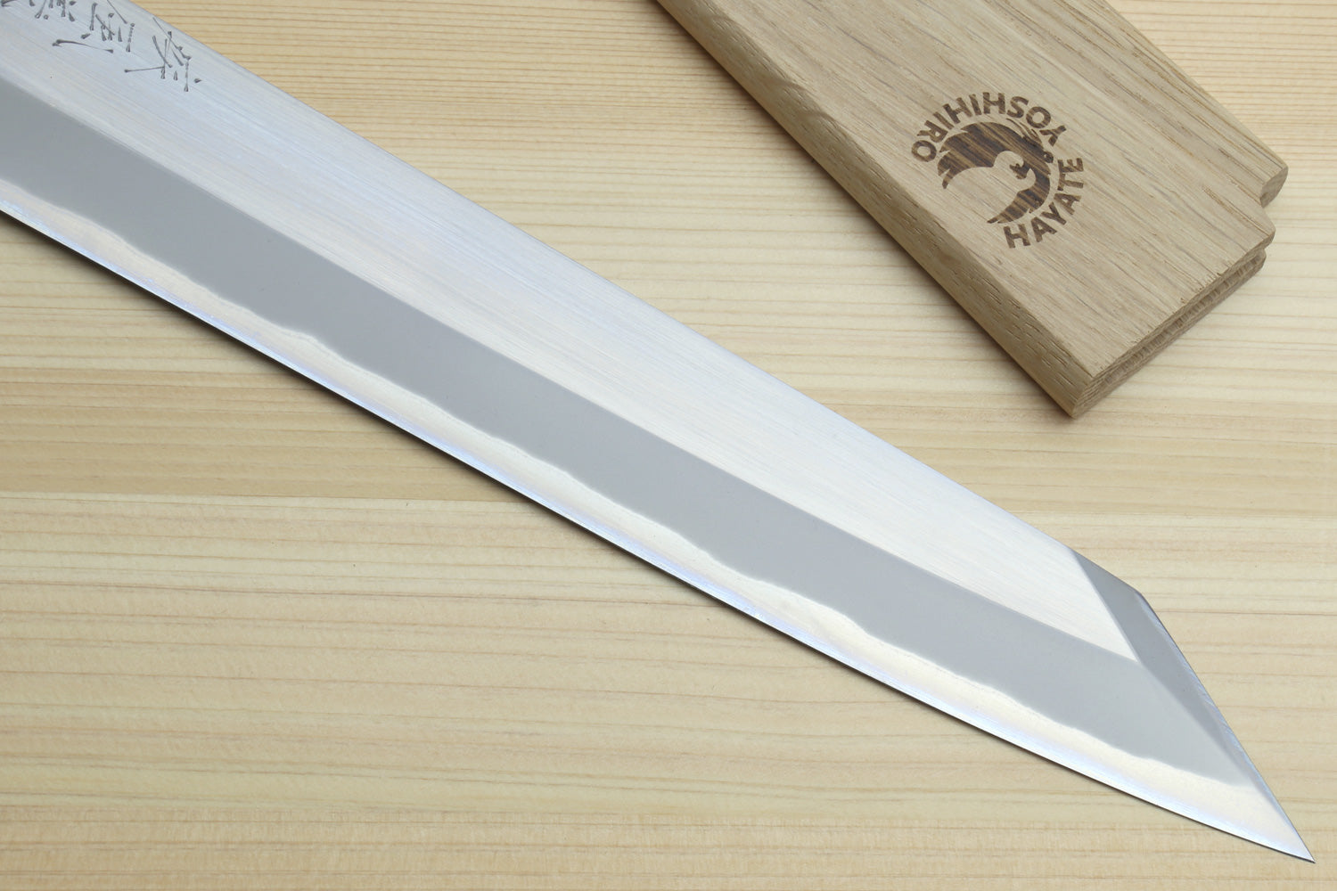 Yanagi-kiritsuke knife showing long white blade, sharp pointed tip