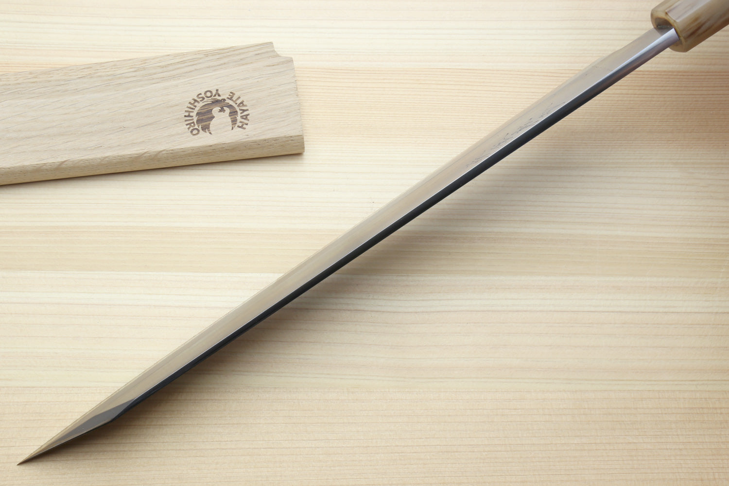 Japanese yanagi-kiritsuke knife with long white steel blade and dark handle