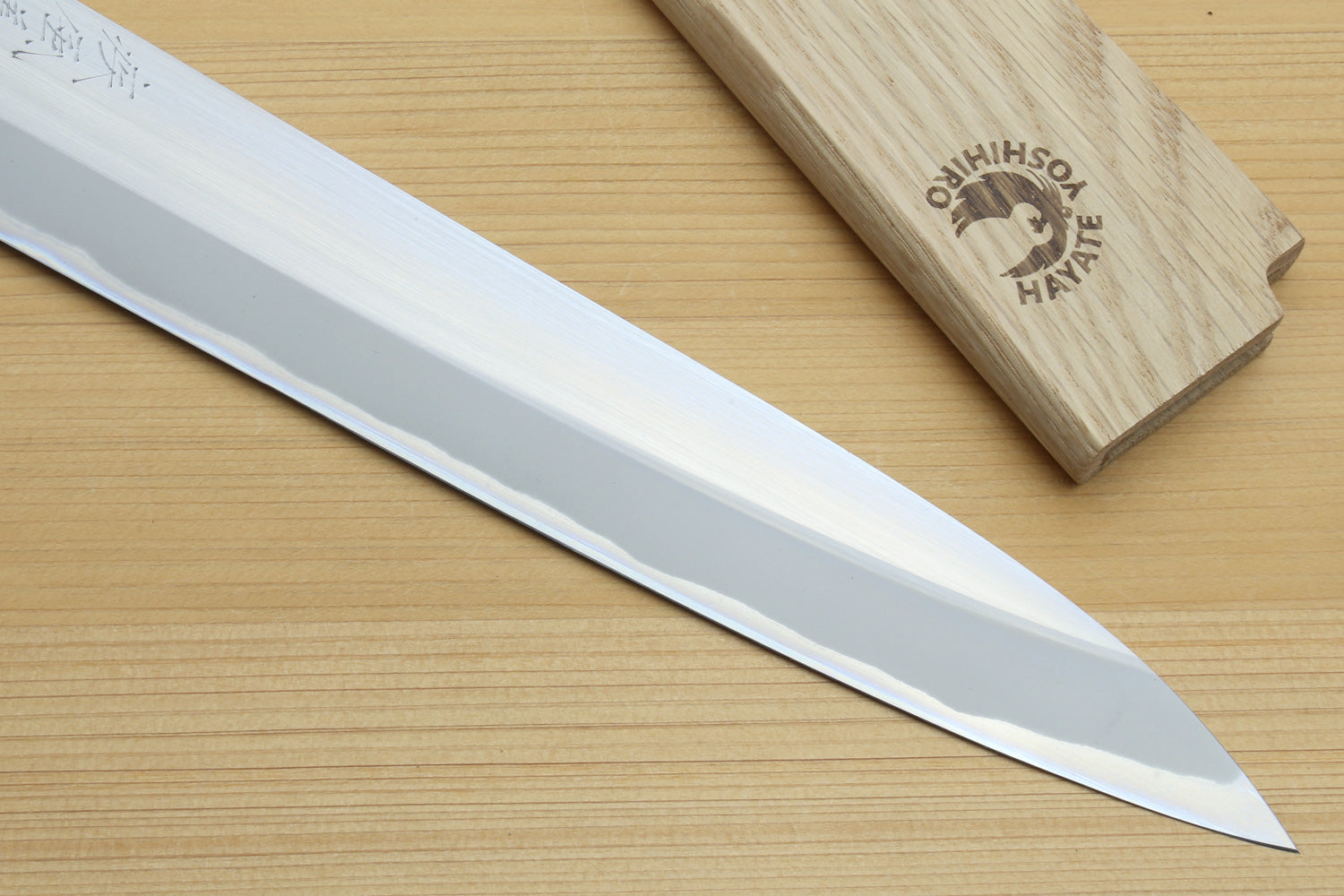 Yanagiba sushi knife with long white blade and dark handle