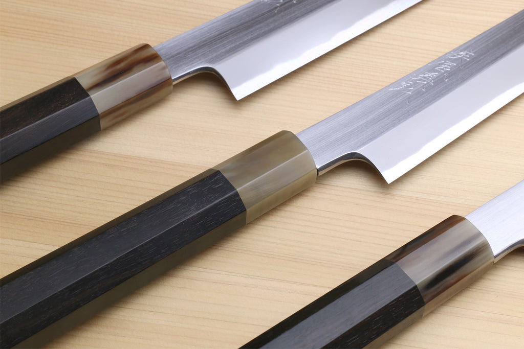 Set of two Japanese yanagiba knives with dark handles and polished silver blades