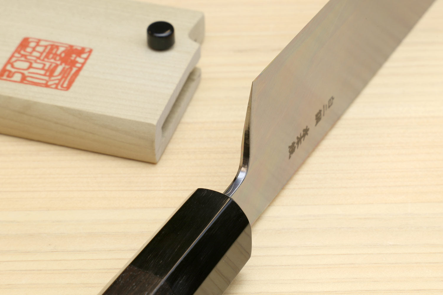 Japanese vegetable knife side view with dark ebony handle and white blade