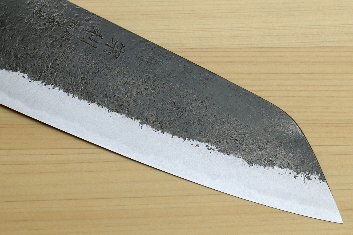 Japanese Bunka chef knife tip and cutting edge with white steel bevel