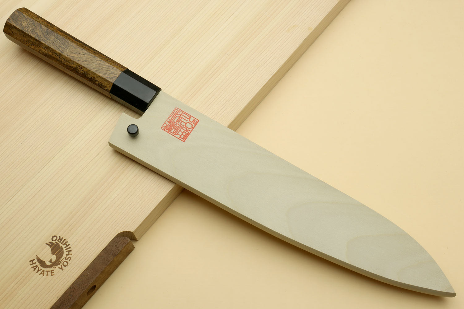 Japanese gyuto chef knife with curved white blade and cocobolo handle, black collar
