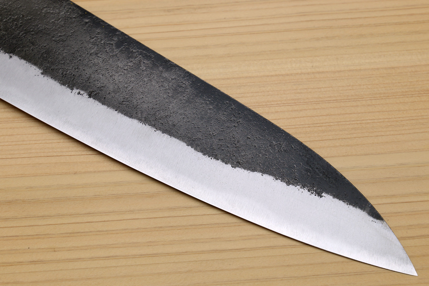 Japanese gyuto chef knife with pointed white steel blade edge and hammered finish