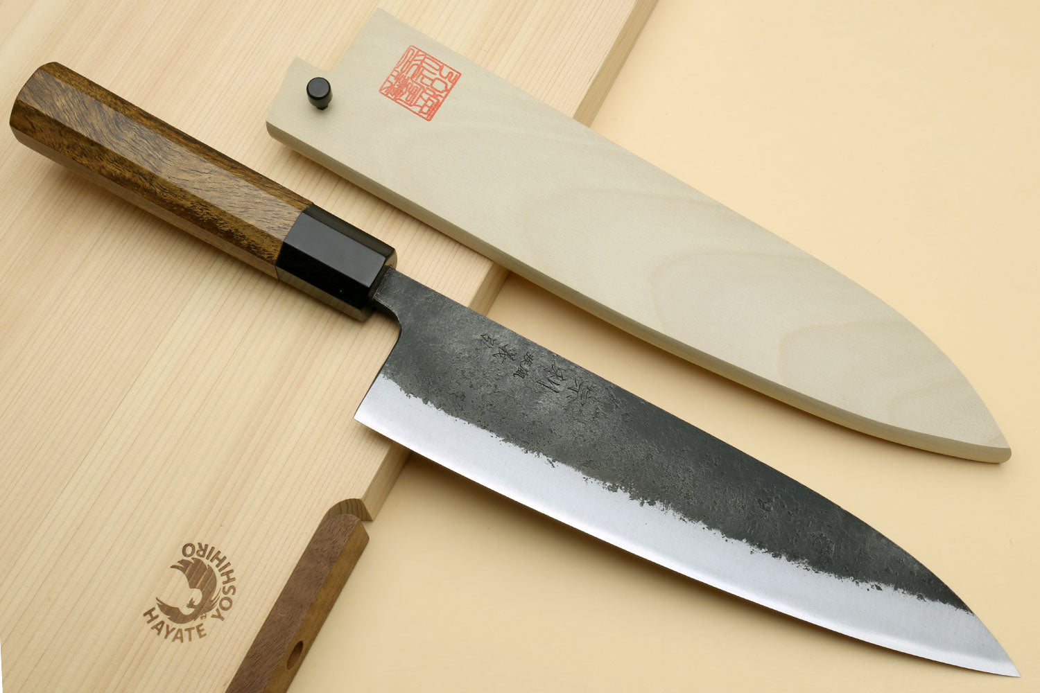 Japanese gyuto chef knife with white blade and cocobolo handle, black collar details
